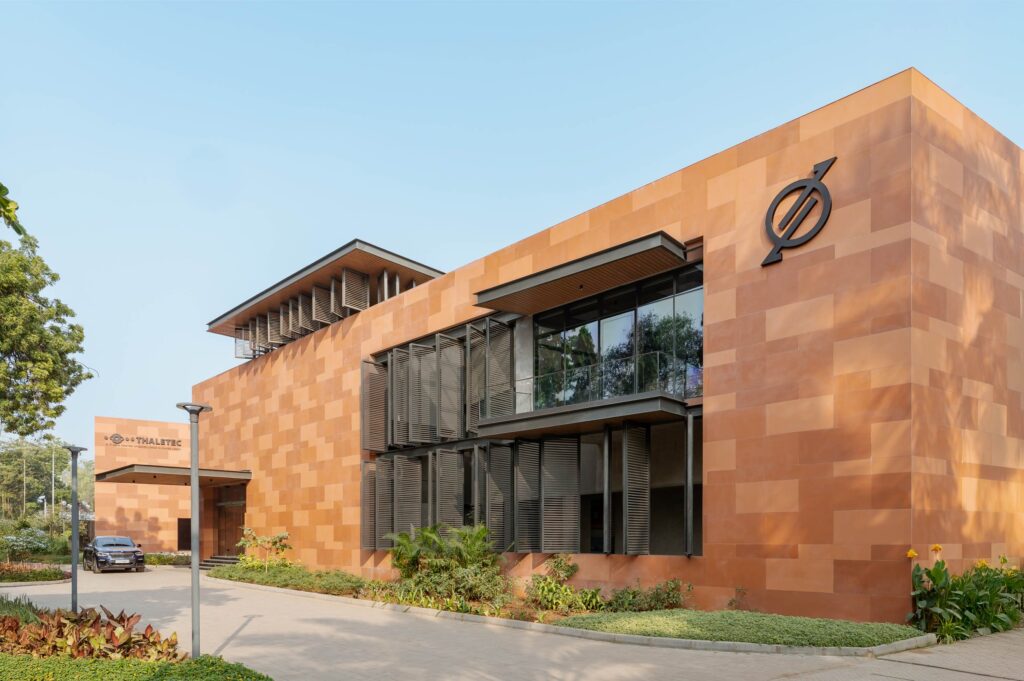 Commercial building entrance showcasing terracotta cladding in facade material selection.