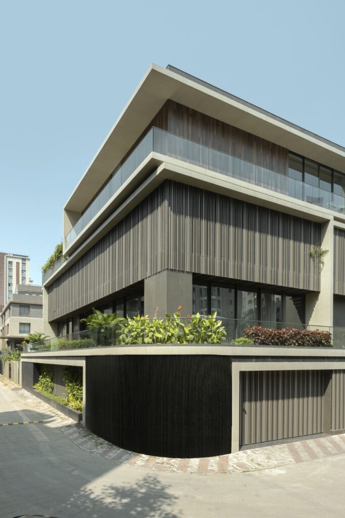 Modern multi-story villa illustrating facade material selection with vertical louvers and concrete elements.