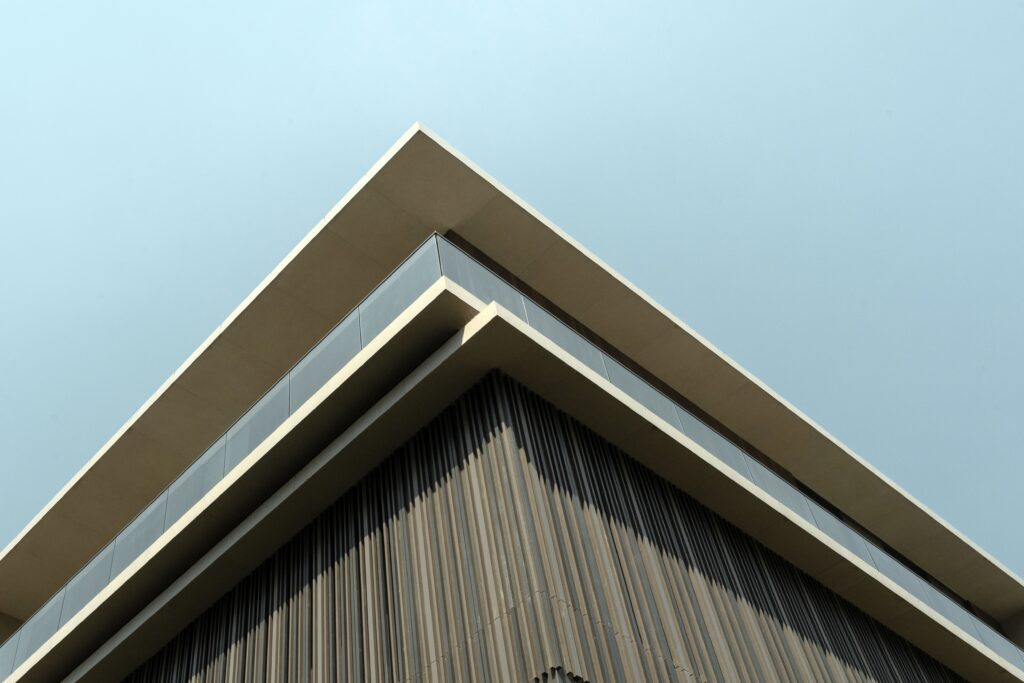 Low-angle shot highlighting modern facade material selection with sharp architectural lines.