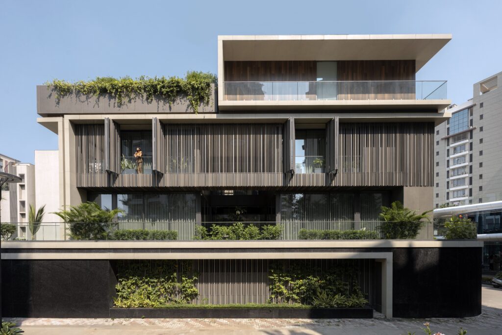 Modern residential building demonstrating clever facade material selection with vertical louvers.