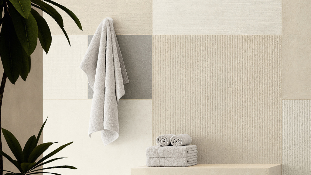 Bathroom interior with neutral textured ceramic wall tiles in linear and geometric patterns creating material contrast
