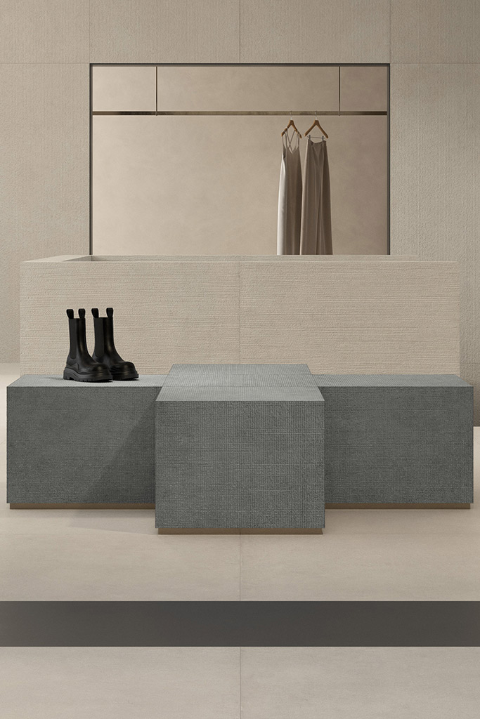 Minimalist retail interior with light textured ceramic wall cladding and clean architectural lines